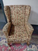 A mid century tapestry upholstered fireside chair