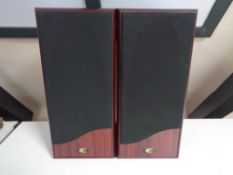 A pair of speakers in rosewood effect finish