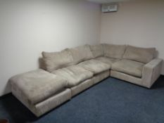 A contemporary corner settee with oversized footstool in corded fabric