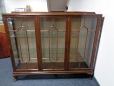 An Edwardian mahogany triple door display cabinet on Queen Anne style legs