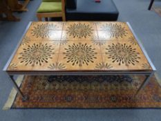A twentieth century Danish tiled coffee table on metal legs
