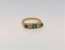 An 18ct gold emerald and diamond ring, approximately 0.
