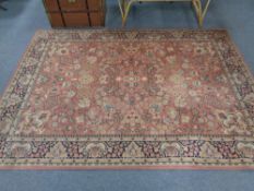 A floral woolen rug on pink ground