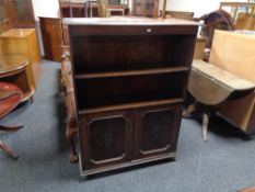 A set of Edwardian oak bookshelves with cupboard beneath