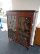 A Victorian mahogany double door bookcase on Queen Anne style legs