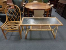 A bamboo and glass topped coffee table together with a chair