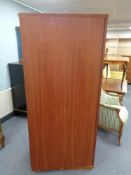 A mid century teak single door wardrobe
