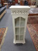 A cream painted narrow cabinet