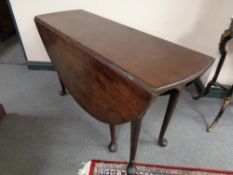 A Victorian mahogany gateleg table on club feet