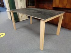 A contemporary dining table on pine legs