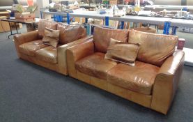 A pair of tan leather two seater settees