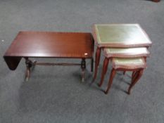 A nest of three glass and leather topped tables together with a flap sided coffee table