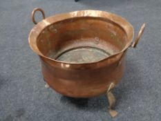 An Art Nouveau copper twin handled planter on raised feet , diameter 41 cm.