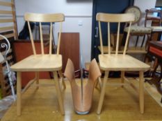 A pair of pine spindle backed dining chairs and contemporary magazine rack