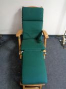 A teak steamer garden chair with adjustable foot rest and cushion