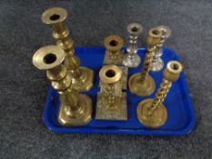 A tray of three pairs of brass candlesticks and further pair of plated candlesticks