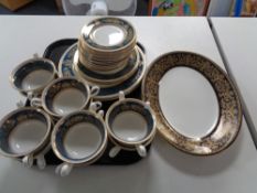 A tray of thirty pieces of Wedgwood Columbia blue and gold tea and dinner china,