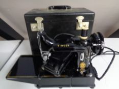 A Singer electric sewing machine in case