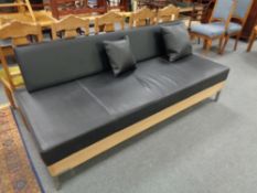 A contemporary black vinyl day bed