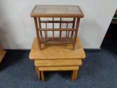 A nest of three oak tables together with a mid century tiled magazine rack