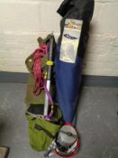 A box of rock climbing equipment, boots, helmet, ropes, axe,