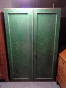 An antique pine painted double door cabinet