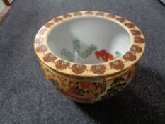 A glazed pottery fish bowl planter