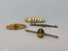 Four 9ct gold brooches, one set with ruby and diamond CONDITION REPORT: 11.