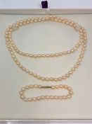 A cultured pearl necklace and similar bracelet with gold clasp