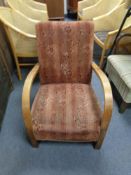 A twentieth century wooden framed armchair upholstered in floral fabric