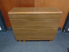 A mid century melamine drop leaf table