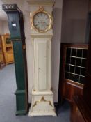 An early twentieth century painted cased continental longcase clock with circular clock by J.