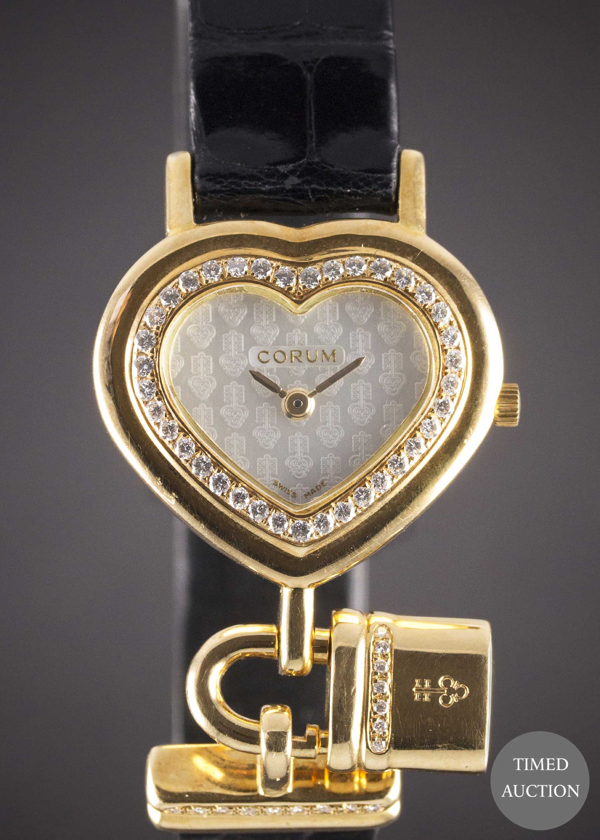 A LADIES 18K SOLID GOLD & DIAMOND CORUM HEART LOCKET WRIST WATCH CIRCA 1990s, REF. 24.181.65 WITH