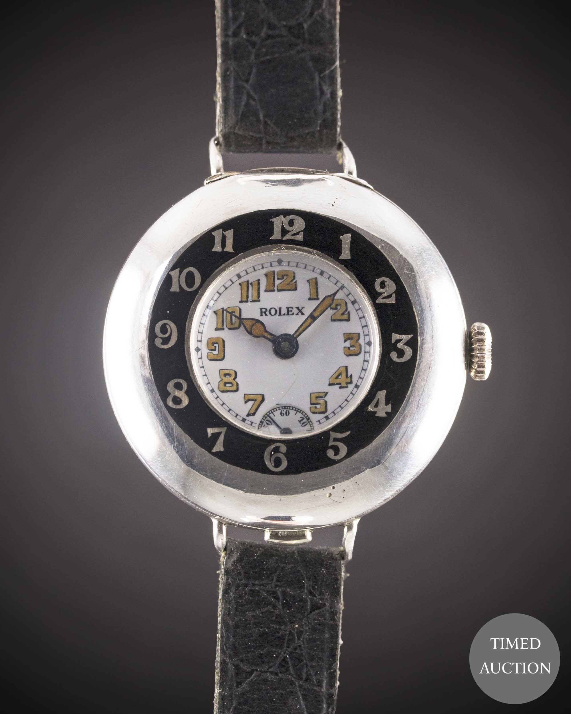 A GENTLEMAN'S SOLID SILVER ROLEX HALF HUNTER OFFICERS WRIST WATCH CIRCA 1920, WITH ENAMEL DIAL