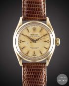 A GENTLEMAN'S 14K SOLID GOLD ROLEX OYSTER PERPETUAL WRIST WATCH CIRCA 1954, REF. 6584 WITH SILVER 