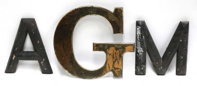 A brass letter 'G' and a quantity of wooden letters