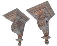 A large pair of walnut carved corbels depicting comedy and tragedy