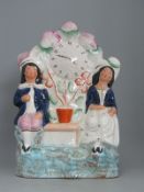 An antique Staffordshire Flat Back - Boy Girl Couple & Painted Watch Clock Face