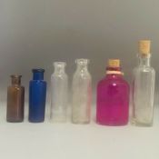A group of 6 small glass medicine or poison bottles