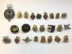 A group of predominantly modern military pin badges