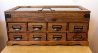Storage Display Unit with glass display top and drawers.
