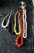 Group of large vintage style brightly coloured knecklaces.