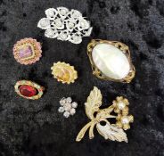 Group of vintage costume brooches and pandant, various materials agea.
