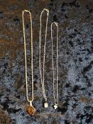 Group lot of white metal pendants and chains.
