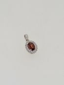 18ct white gold garnet and diamond pendant