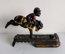 A late Victorian cast metal comical jockey money box, possible maker of J E Stevens, embossed