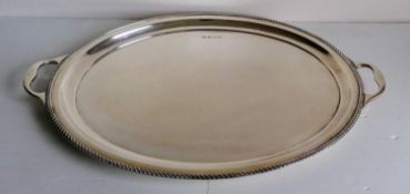 A George V silver two-handled oval butler's tray with gadrooned rim on pad feet, Birmingham, 1922,