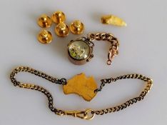 An assortment of 9ct gold items to include compass, map of Australia, hallmarked and five dress