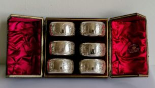 A cased set of six Victorian silver napkin rings with etched decoration, vacant cartouches, by Hayes