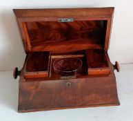 A Georgian mahogany sarcophagus tea caddy with shaped top, fitted interior with etched glass